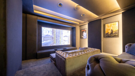Front view of Durbanville home cinema with floating 120-inch screen and M&K Dolby Atmos ceiling speakers