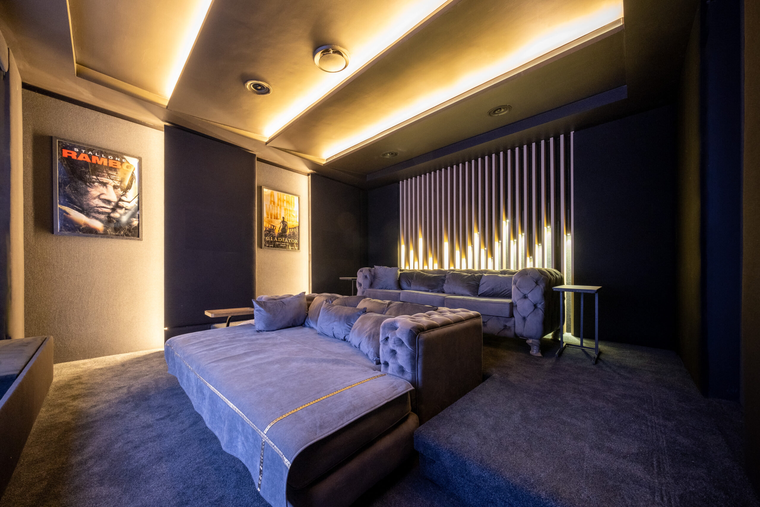 Custom rear wall lighting behind tiered seating in Durbanville home cinema