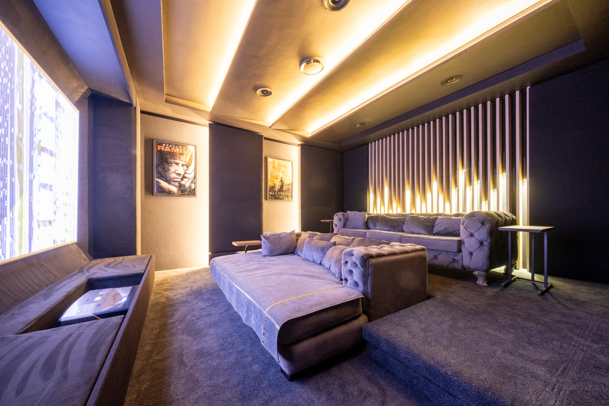 Durbanville home cinema with tiered seating, floating projection screen and layered lighting