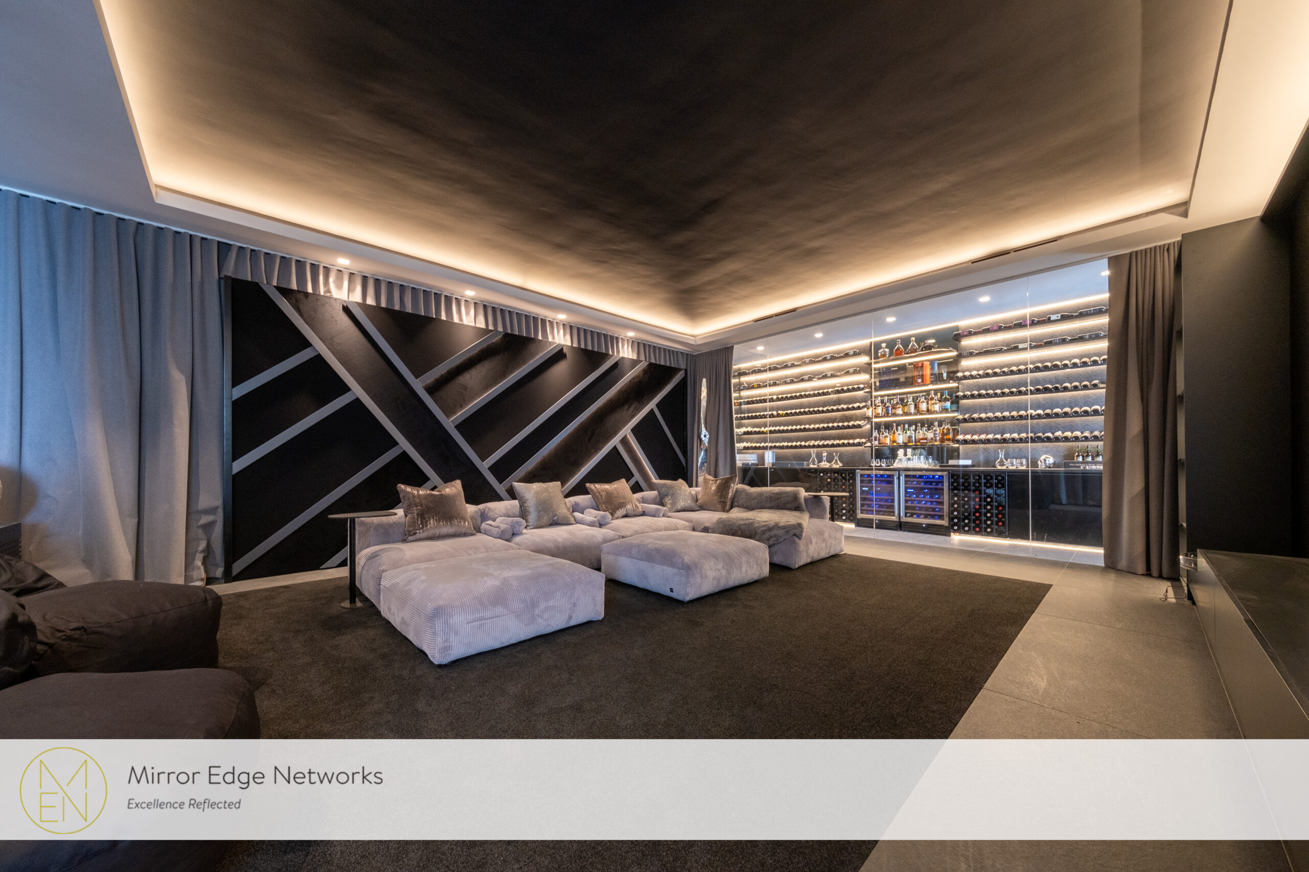 Oranjezicht home cinema with illuminated bar, custom seating and architectural lighting